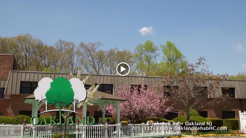 Front exterior of a two-story brick rehabilitation center with a gazebo, flowering trees, and an overlaid logo and contact text.