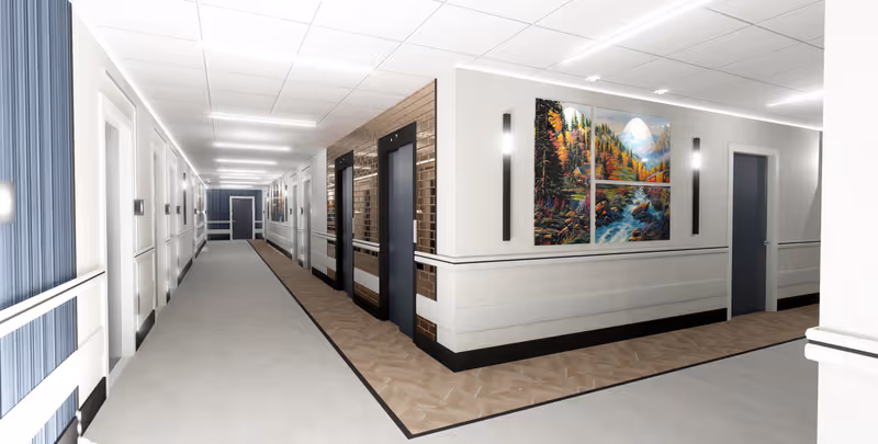A clean, well-lit hallway in a senior living facility with multiple white doors on the left side and two elevators on the right side. The walls are decorated with a large colorful painting of a forest and river scene, and modern wall sconces provide additional lighting. The floor has a combination of light-colored carpet and wood-patterned flooring near the elevators.