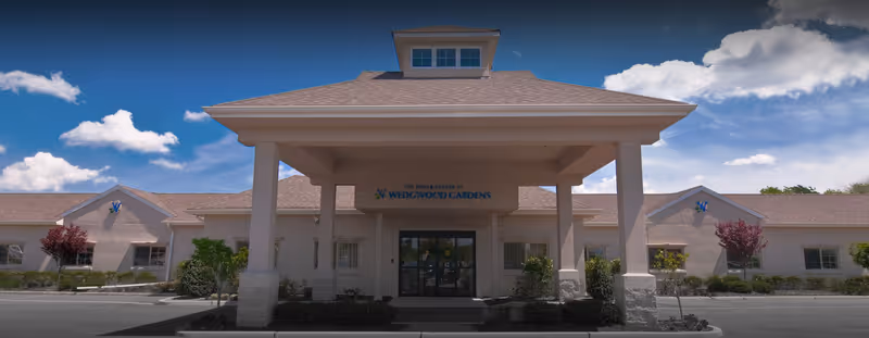Front entrance of The Rehab Center at Wedgwood Gardens with a covered porte-cochere and single-story building façade.